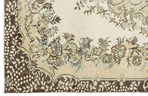Load image 1 in gallery view. Cream, brown, and light blue traditional rug with a floral medallion pattern and a dark brown decorative border.