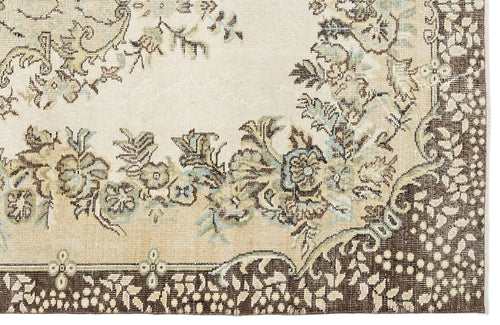 Load image 1 in gallery view. Cream, brown, and sage green traditional rug with a floral medallion pattern and a dark brown border.