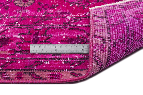 Load image 1 in gallery view. Magenta distressed rug with a black floral medallion pattern, shown with a metal ruler for scale.
