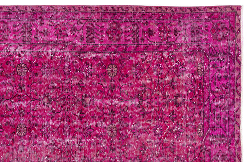 Load image 1 in gallery view. Magenta distressed rug with a traditional floral medallion pattern and a dark border.