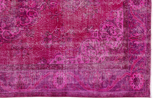 Load image 1 in gallery view. Magenta and deep purple distressed rug with a faded traditional floral medallion pattern.