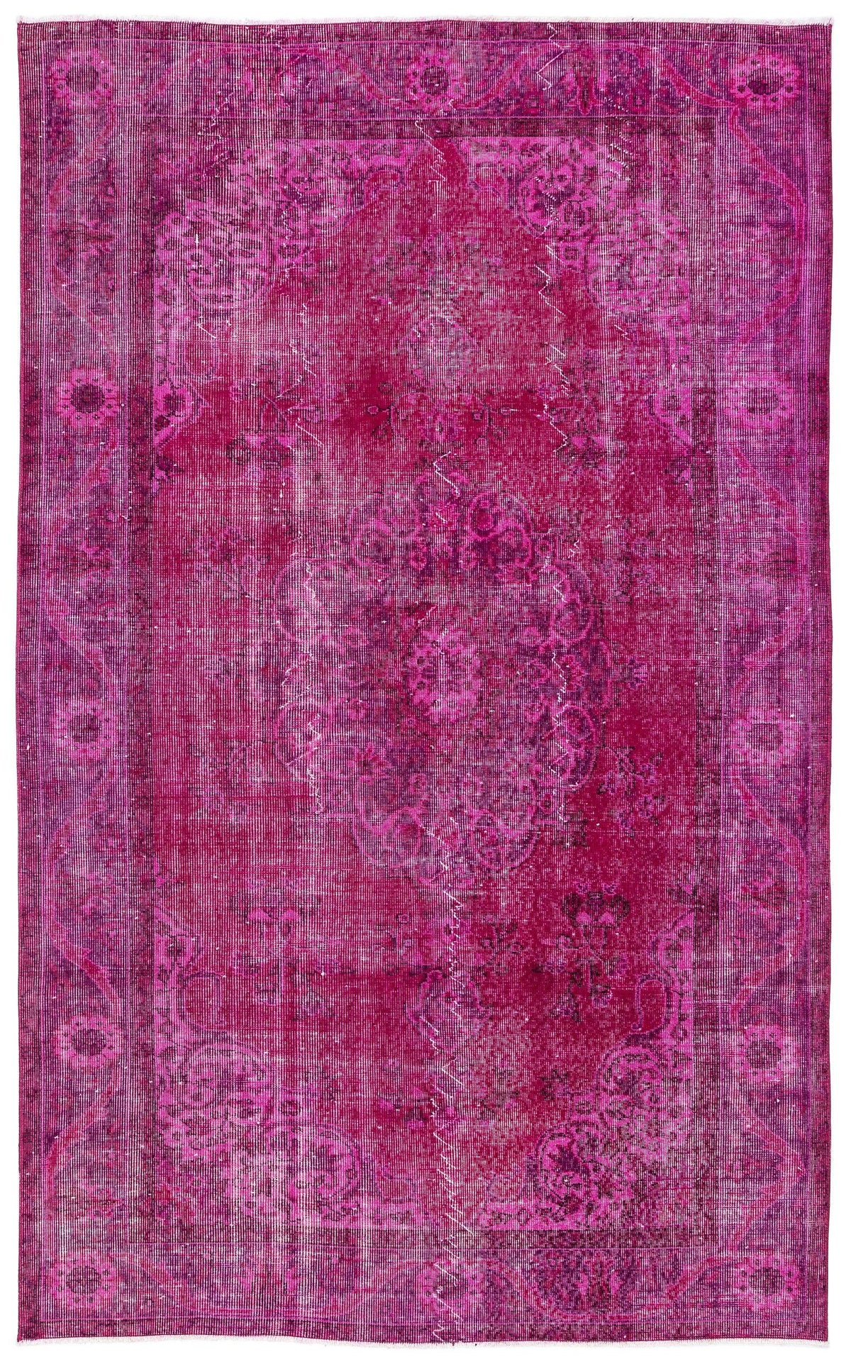 Magenta distressed area rug with a traditional central medallion and ornate border pattern.