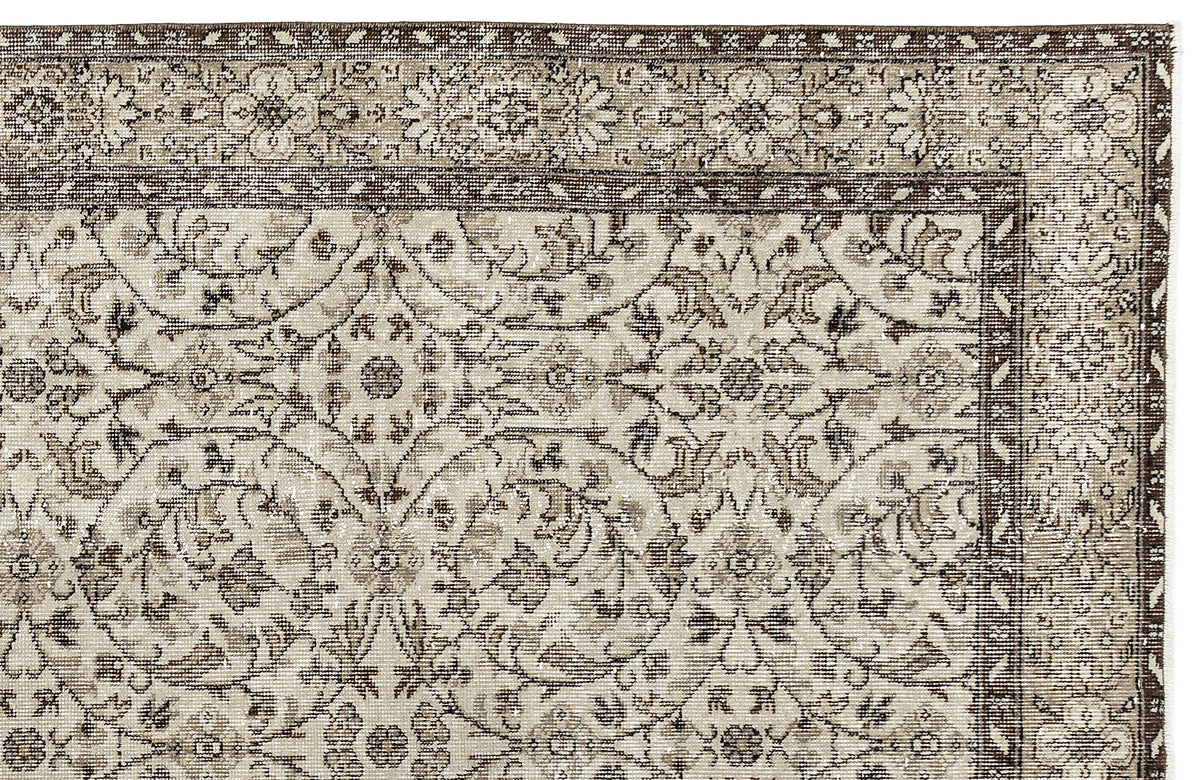 A close-up of the Sigima - Vintage Floral Rug (5'4 x 9'1) showcasing intricate beige and brown floral and vine patterns with a decorative border, in a traditional style reminiscent of Anatolian hand-woven rugs.