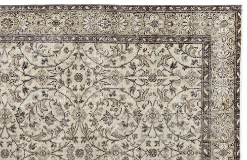 Load image 1 in gallery view. A close-up of the Sigima - Vintage Floral Rug (5'4 x 9'1) showcasing intricate beige and brown floral and vine patterns with a decorative border, in a traditional style reminiscent of Anatolian hand-woven rugs.
