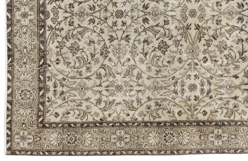 Load image 1 in gallery view. A close-up of the Sigima - Vintage Floral Rug (5'4" x 9'1") shows its beige and brown tones, intricate floral and vine patterns, and decorative border that highlight the artisanal detail of this traditional hand-woven piece.