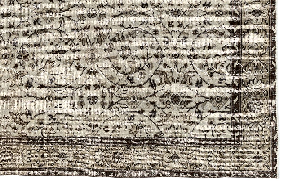 A close-up of the Sigima Vintage Floral Rug (5'4" x 9'1") shows its intricate beige and brown floral and vine design, highlighted by a detailed decorative border.