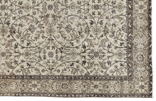 Load image 1 in gallery view. A close-up of the Sigima Vintage Floral Rug (5'4" x 9'1") shows its intricate beige and brown floral and vine design, highlighted by a detailed decorative border.