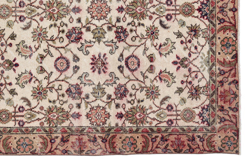 Load image 1 in gallery view. Beige traditional rug with a floral medallion pattern in muted red, green, and navy blue, featuring a decorative border.