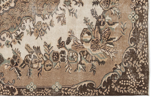 Load image 1 in gallery view. Distressed brown, beige, and sage green rug with a traditional floral medallion pattern.