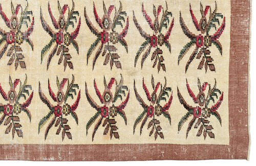 Load image 1 in gallery view. Cream rug with a repeating red, green, and brown floral motif and a solid brown border.