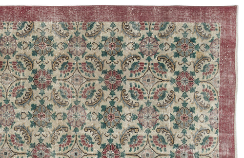 Load image 1 in gallery view. Beige vintage-style rug with a red border and a repeating floral medallion pattern in red, green, and blue.
