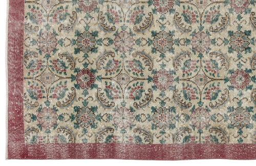 Load image 1 in gallery view. Beige rug with a distressed floral medallion pattern in red, green, and blue, featuring a solid red border.