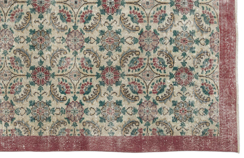 Load image 1 in gallery view. Beige rug with a distressed floral medallion pattern in red, green, and blue, featuring a solid red border.