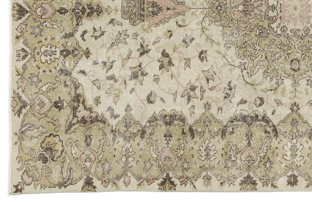A detailed view of the Kaugila Vintage Medallion Rug (5'9 x 9'0) reveals ornate floral borders, faded beige, olive, and brown hues, and intricate patterns with a distressed antique look inspired by Anatolian heritage designs.