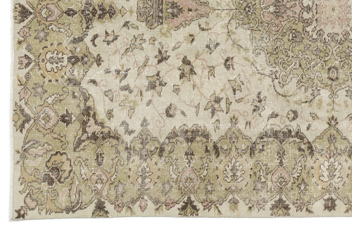 Load image 1 in gallery view. A detailed view of the Kaugila Vintage Medallion Rug (5'9 x 9'0) reveals ornate floral borders, faded beige, olive, and brown hues, and intricate patterns with a distressed antique look inspired by Anatolian heritage designs.