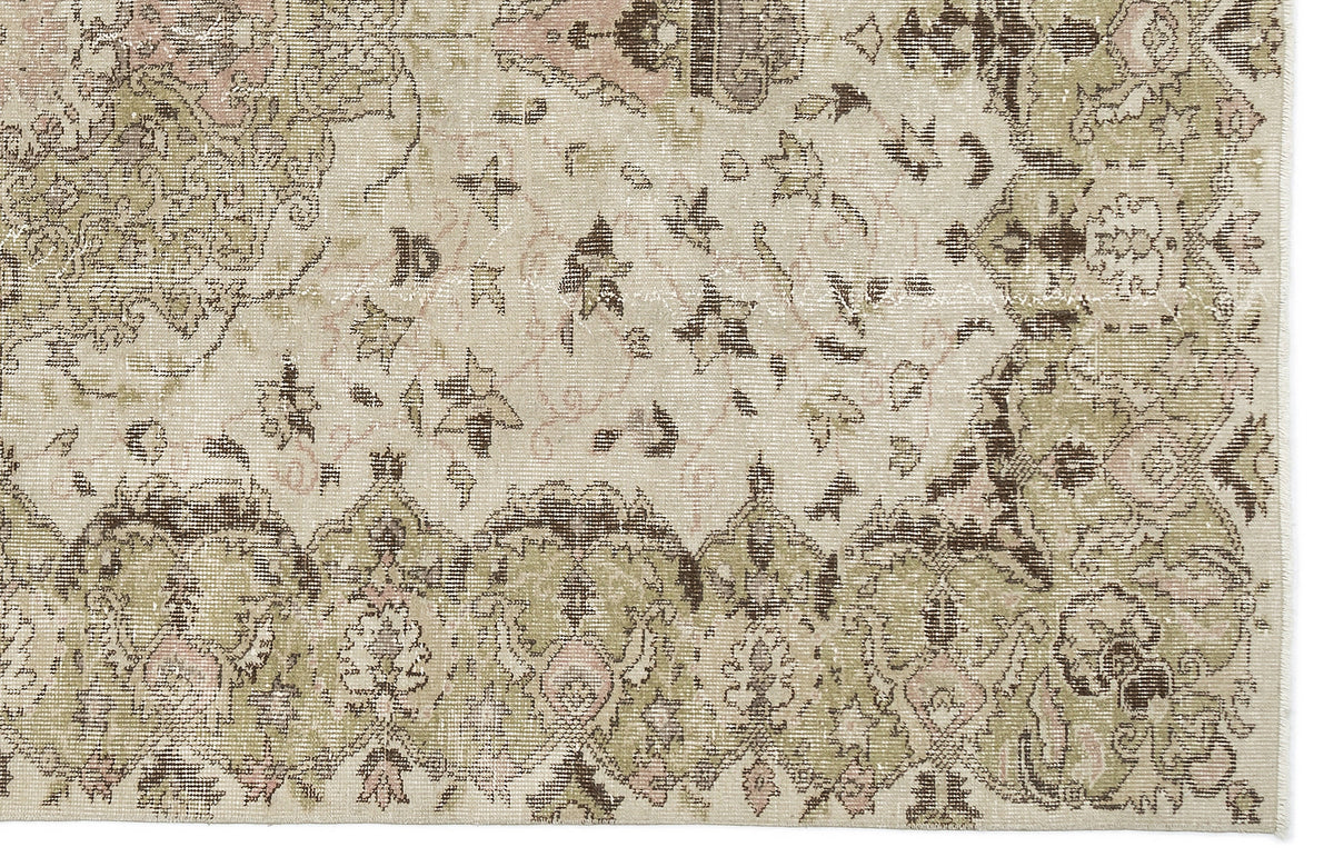 A close-up of the Kaugila - Vintage Medallion Rug (5'9 x 9'0) highlights its intricate floral and geometric designs in soft beige, olive green, brown, and pink tones.