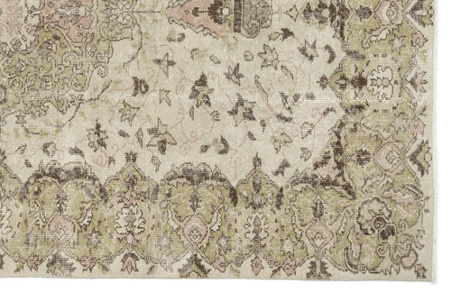 Load image 1 in gallery view. A close-up of the Kaugila - Vintage Medallion Rug (5'9 x 9'0) highlights its intricate floral and geometric designs in soft beige, olive green, brown, and pink tones.