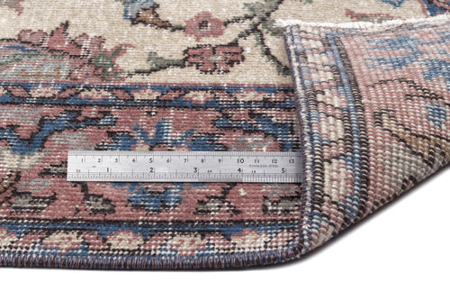 Load image 1 in gallery view. Beige, blue, and pink floral patterned rug with a folded corner revealing the woven backing and a metal ruler for scale.