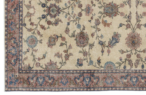Load image 1 in gallery view. Beige rug with a distressed floral vine pattern in muted blue, red, and brown, featuring a decorative border.