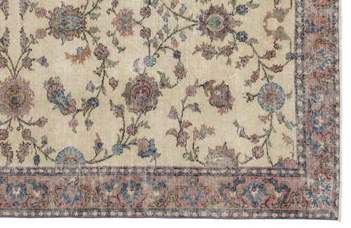 Load image 1 in gallery view. Beige rug with a distressed floral vine pattern in muted blue, red, and green, featuring a decorative border.