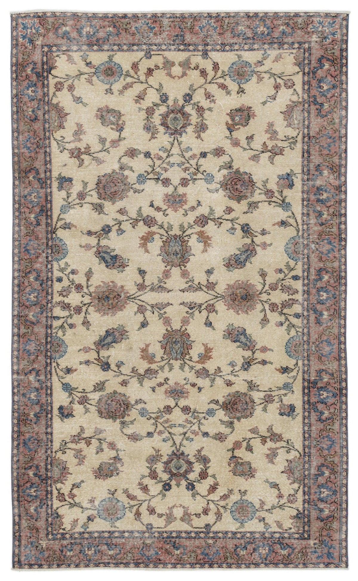 Beige vintage-style rug with a faded floral medallion pattern in muted blue and dusty rose, isolated on white.