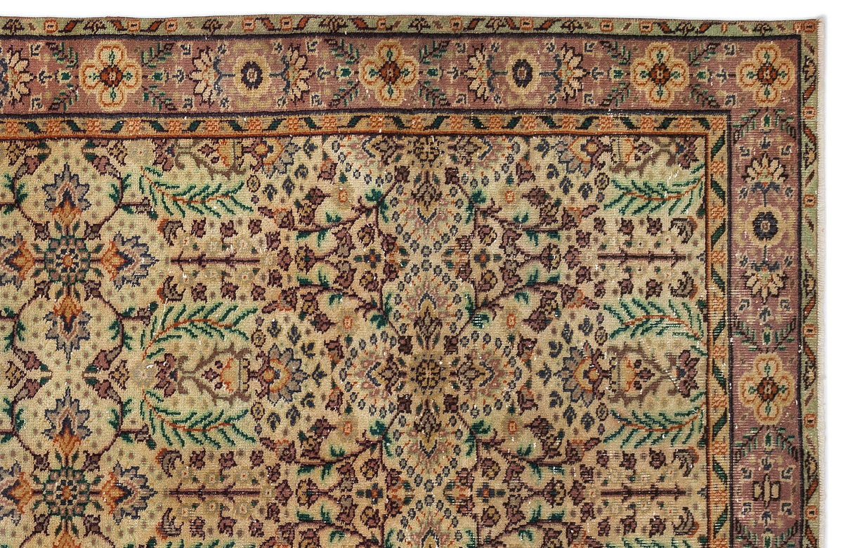 Traditional Persian-style rug with a beige field, intricate floral motifs, and a mauve border with repeating medallions.