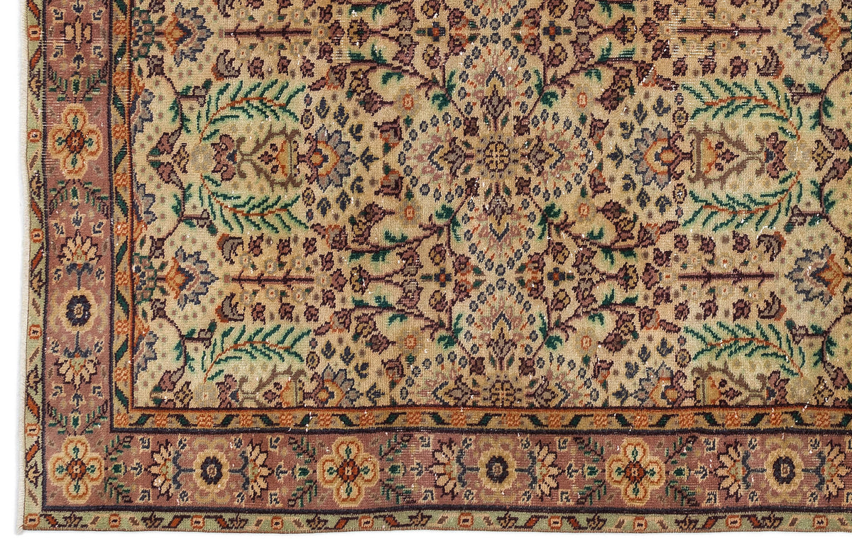 Beige traditional rug with a multi-colored floral medallion pattern and a wide, ornate mauve border.