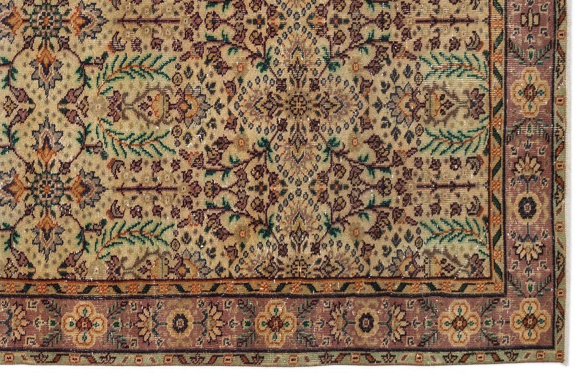 Traditional Persian-style rug with a beige field, intricate floral motifs in green and plum, and a wide decorative border.