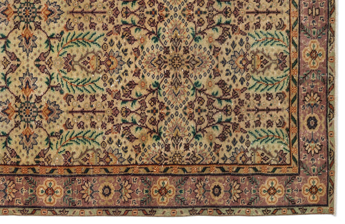 Load image 1 in gallery view. Traditional Persian-style rug with a beige field, intricate floral motifs in green and plum, and a wide decorative border.