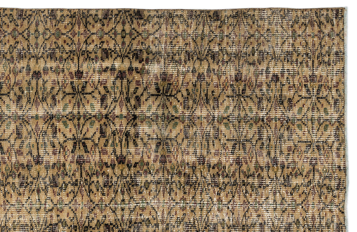 Tan and brown vintage-style rug with a distressed, repeating geometric lattice pattern and subtle green and maroon accents.