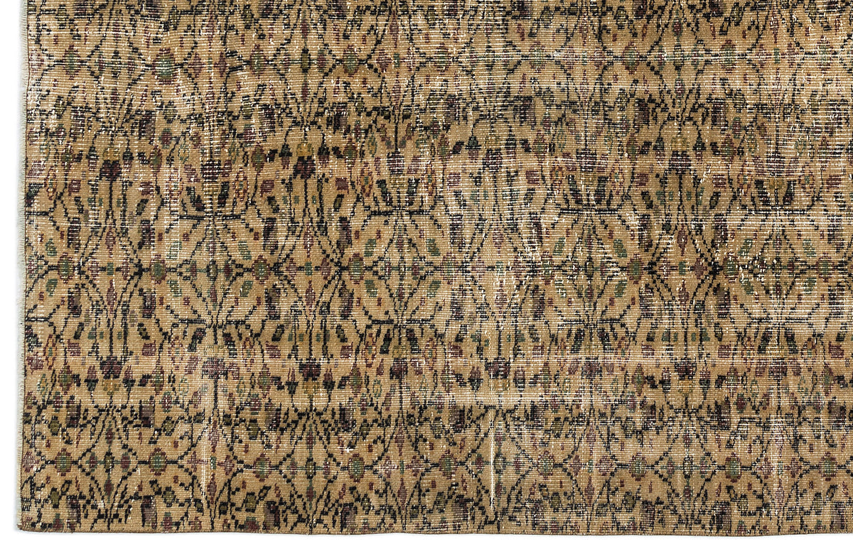 Tan and brown distressed rug with a repeating black geometric lattice pattern and small floral accents.