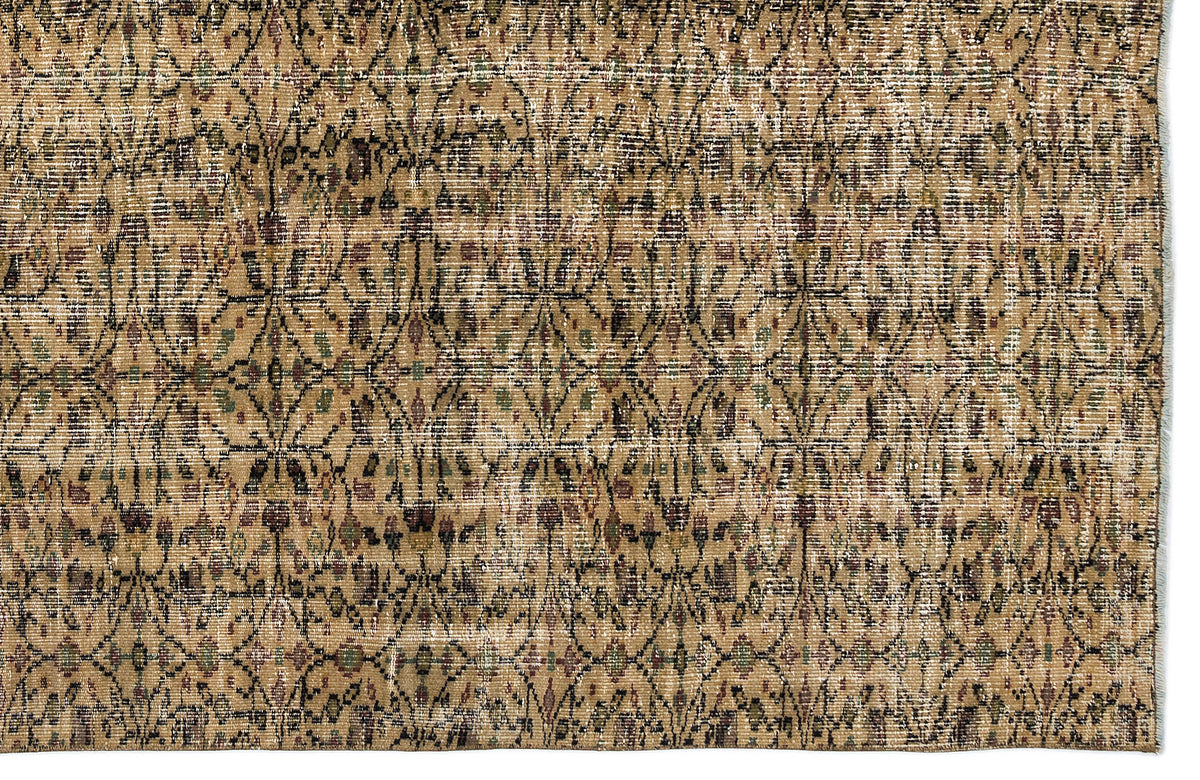 Tan and brown vintage-style rug with a distressed, repeating geometric lattice pattern and subtle multicolored accents.