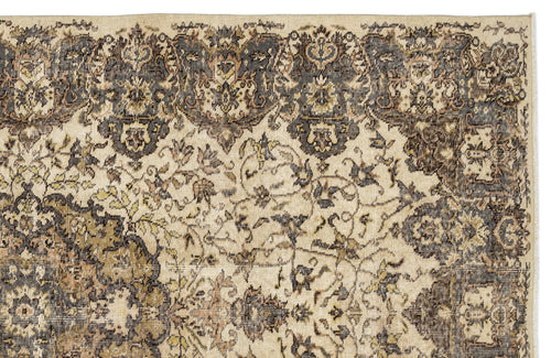 Load image 1 in gallery view. Distressed beige and charcoal rug with a traditional floral medallion border and intricate vine pattern.