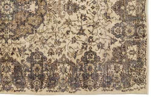 Load image 1 in gallery view. Beige and charcoal traditional rug with a distressed floral medallion pattern and a fringed edge.