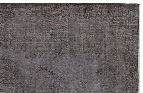 Load image 1 in gallery view. Dark charcoal and grey distressed rug with a faded traditional floral medallion pattern.