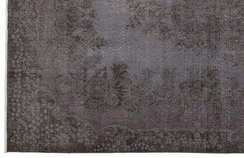 Load image 1 in gallery view. Charcoal grey rug with a faded, traditional floral medallion pattern and a decorative border.