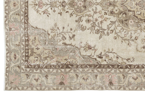 Load image 1 in gallery view. Distressed beige and brown traditional rug with a faded floral medallion pattern and intricate geometric border.