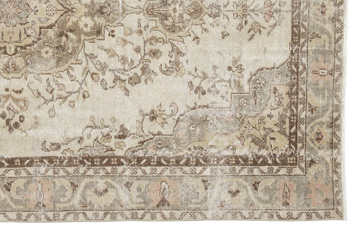 Load image 1 in gallery view. Distressed beige and brown traditional rug with a faded floral medallion pattern and a detailed geometric border.