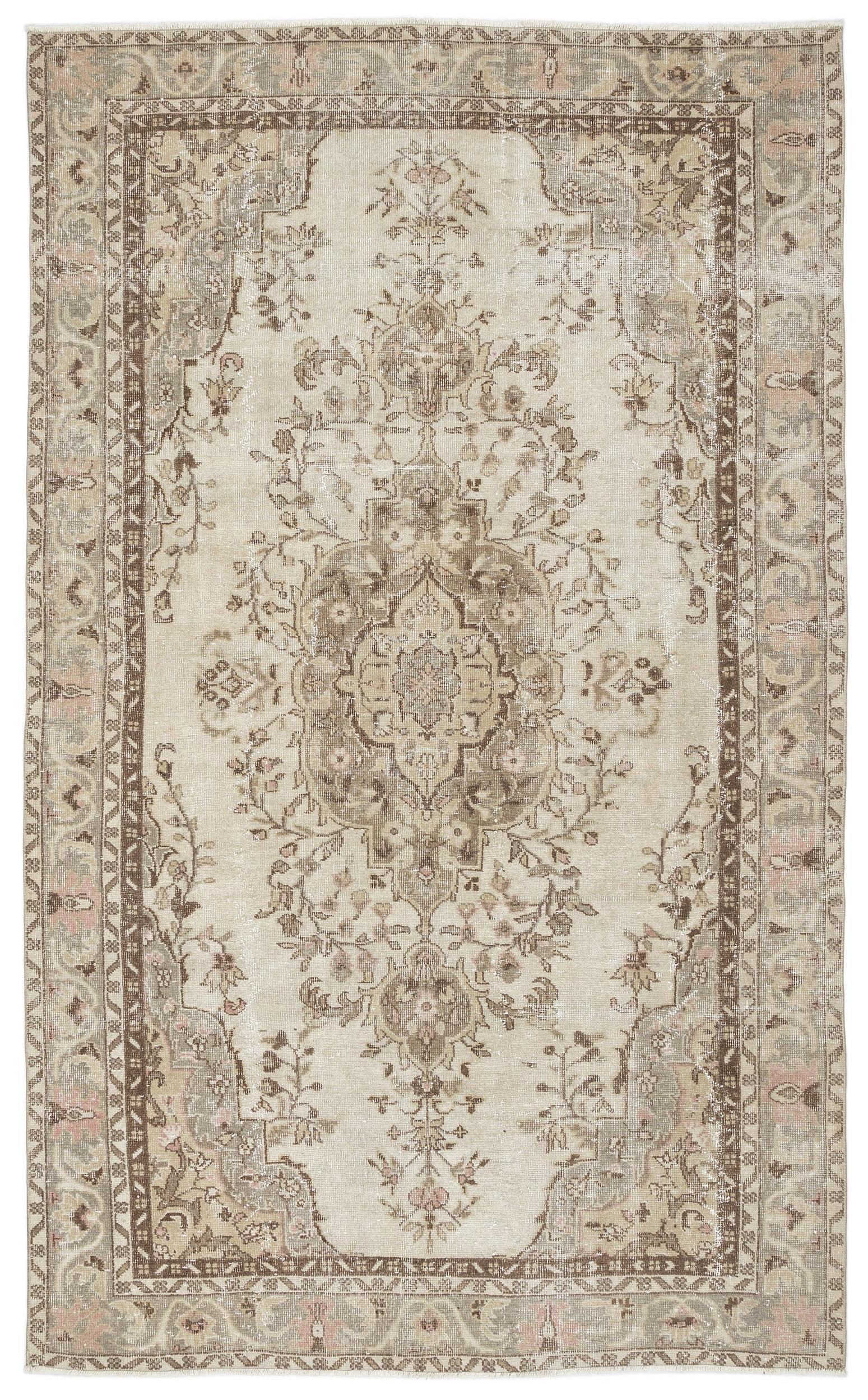 Beige and brown traditional rug with a distressed floral medallion pattern and a decorative border.