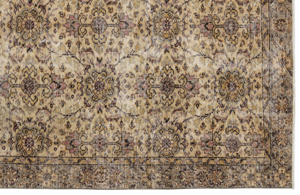 Distressed beige and brown traditional rug with a repeating floral medallion pattern and a dark border.