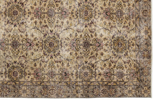 Load image 1 in gallery view. Distressed beige and brown traditional rug with a repeating floral medallion pattern and a dark border.