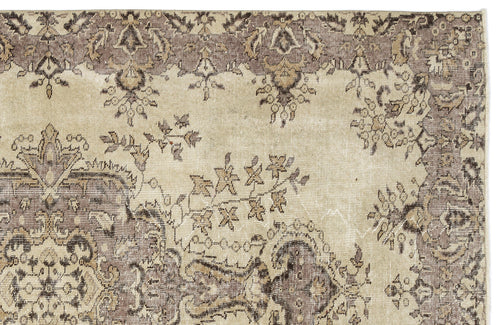 Load image 1 in gallery view. Distressed beige and taupe rug with a traditional floral medallion pattern and ornate border.