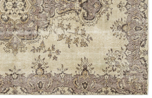 Load image 1 in gallery view. Beige and taupe vintage-style rug with a distressed floral medallion pattern.