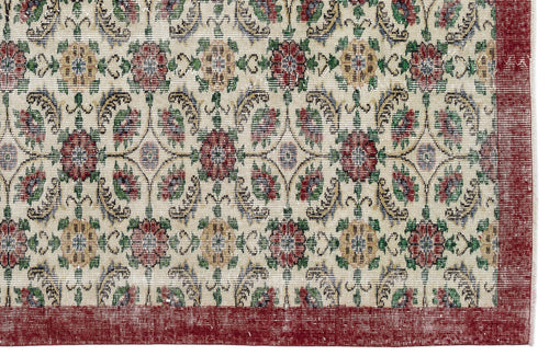 Load image 1 in gallery view. Cream rug with a repeating floral medallion pattern in red, green, and gold, featuring a wide solid red border.