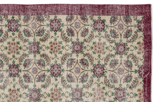 Load image 1 in gallery view. Beige rug with a repeating floral medallion pattern in burgundy, green, and tan, featuring a wide burgundy border.