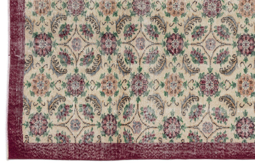 Load image 1 in gallery view. Beige rug with a maroon border and a repeating floral medallion pattern in maroon, green, and muted blue.