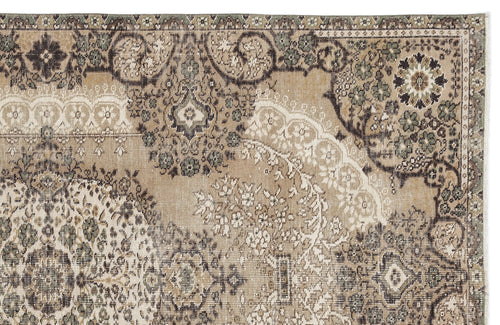 Load image 1 in gallery view. Tan, brown, and sage green traditional rug with a distressed, faded floral medallion pattern.