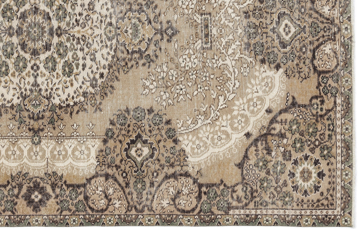 Beige, brown, and sage green rug with a distressed traditional floral medallion pattern.