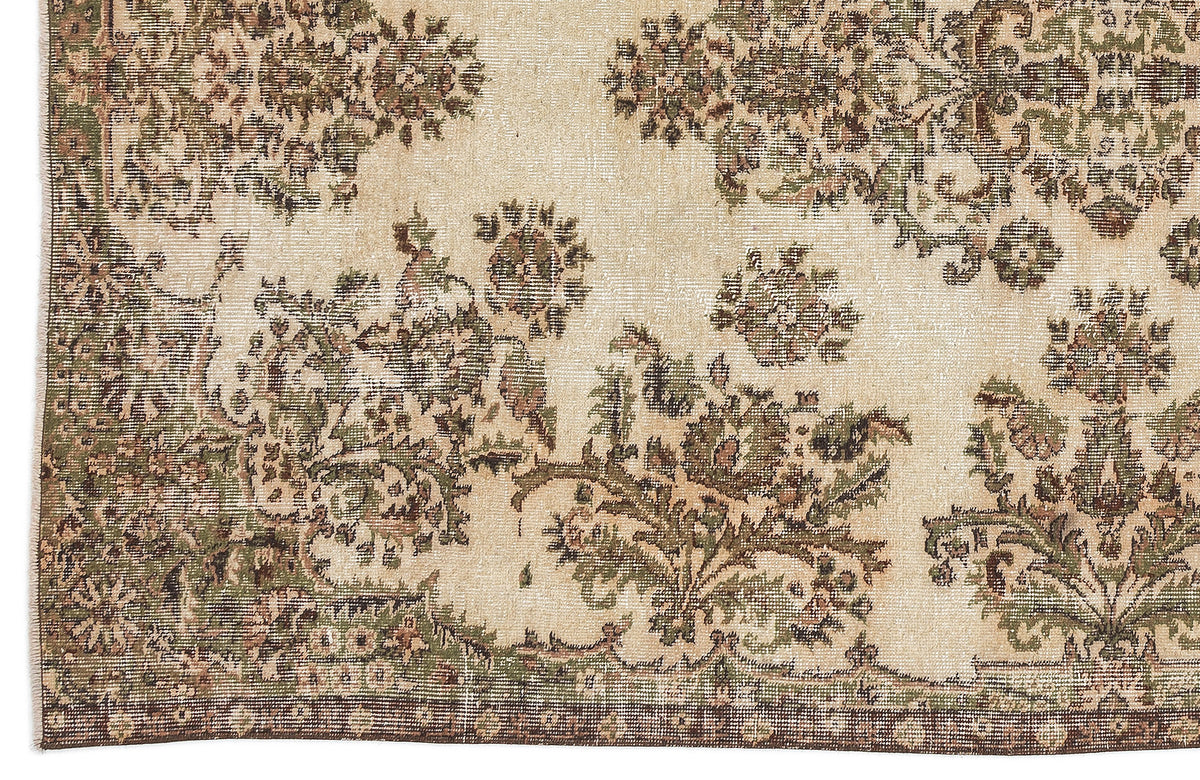 Distressed beige rug with olive green and brown floral medallion patterns and a dark border.