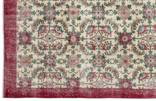 Load image 1 in gallery view. Beige rug with a red border and a repeating floral medallion pattern in red, green, and muted blue.